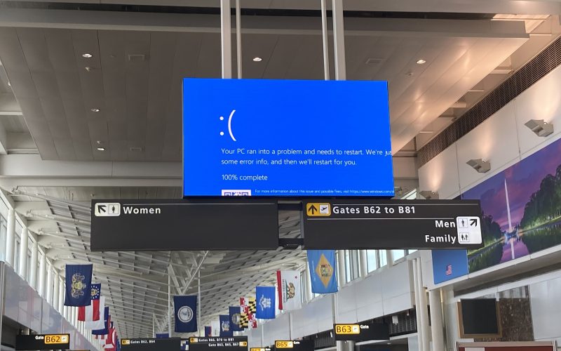 Information screen at airport giving microsoft blue screen of death error