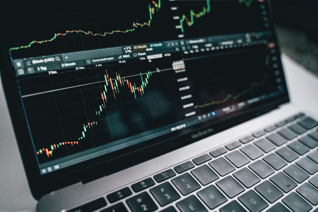 Laptop screen with price candlestick chart