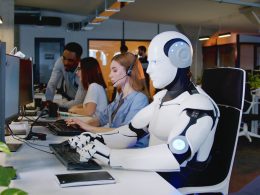 Robot working on a computer in office