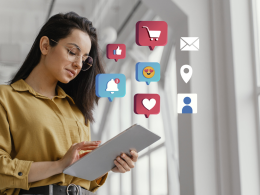 Girl holding the tablet with social media icons