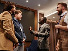 Professionals engaging in conversation at a networking event, demonstrating effective business networking tips for building connections.