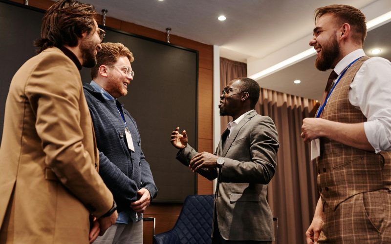 Professionals engaging in conversation at a networking event, demonstrating effective business networking tips for building connections.