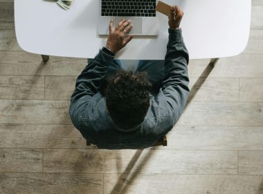 Person using a laptop and credit card, symbolizing online financial freedom