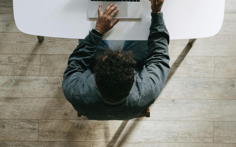 Person using a laptop and credit card, symbolizing online financial freedom